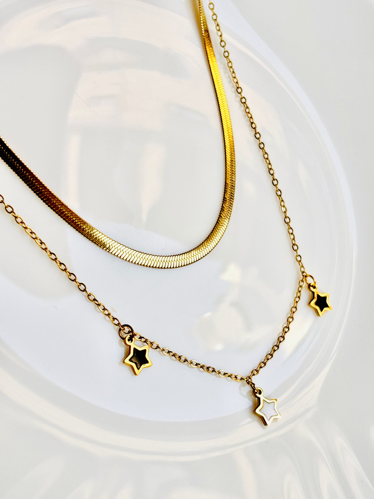 Gold necklaces with star pendants; snake chain; classy; trend