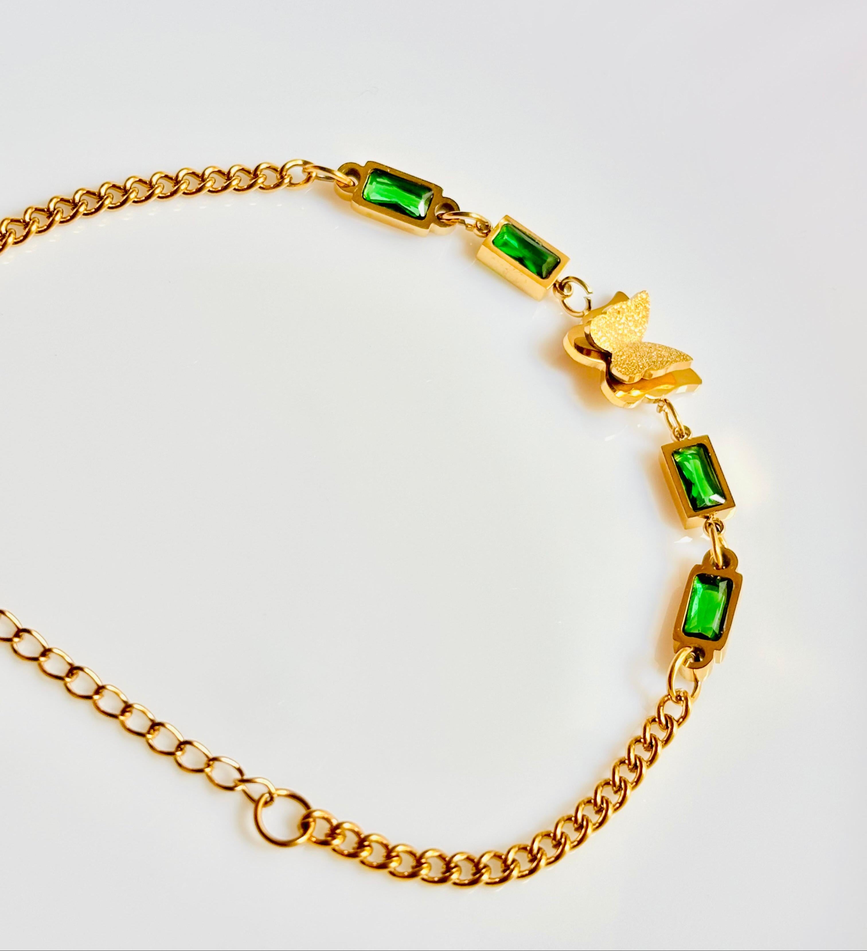 Gold butterfly bracelet with green gemstones