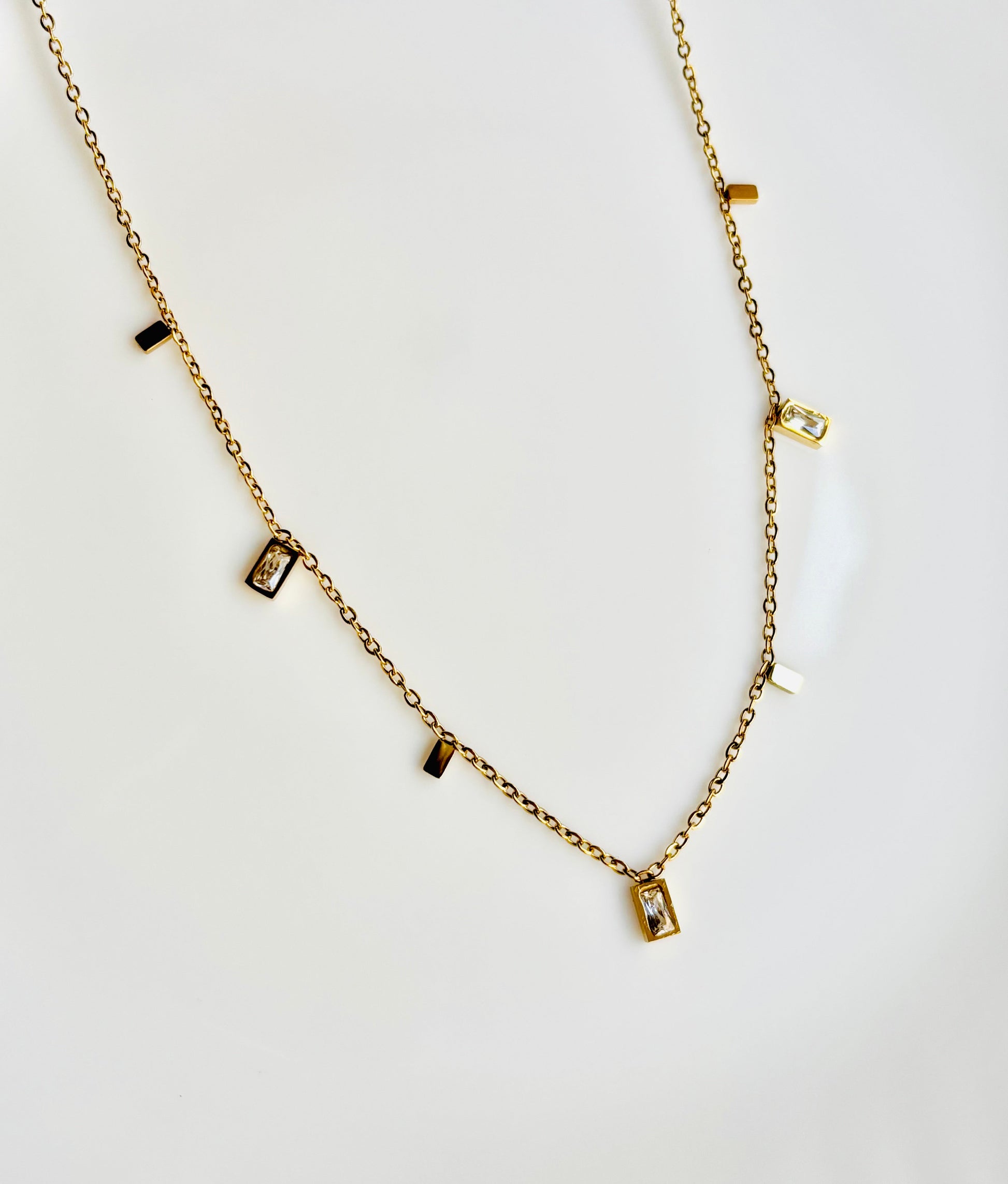 Gold necklace with small rectangular pendants