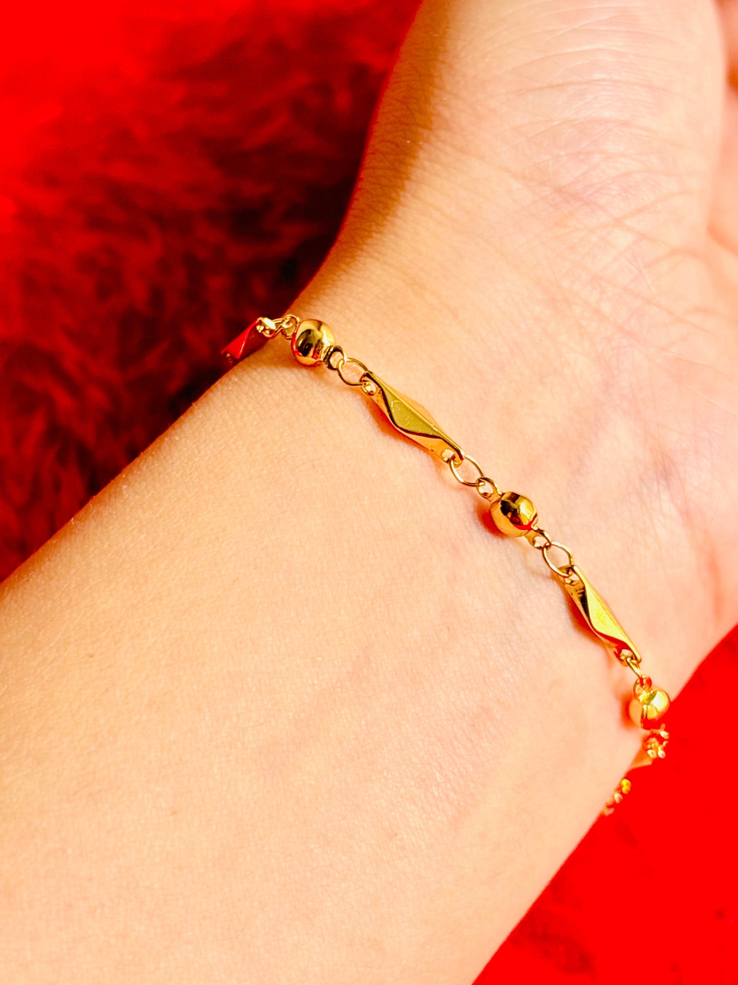 Gold bracelet on a wrist; hypoallergenic