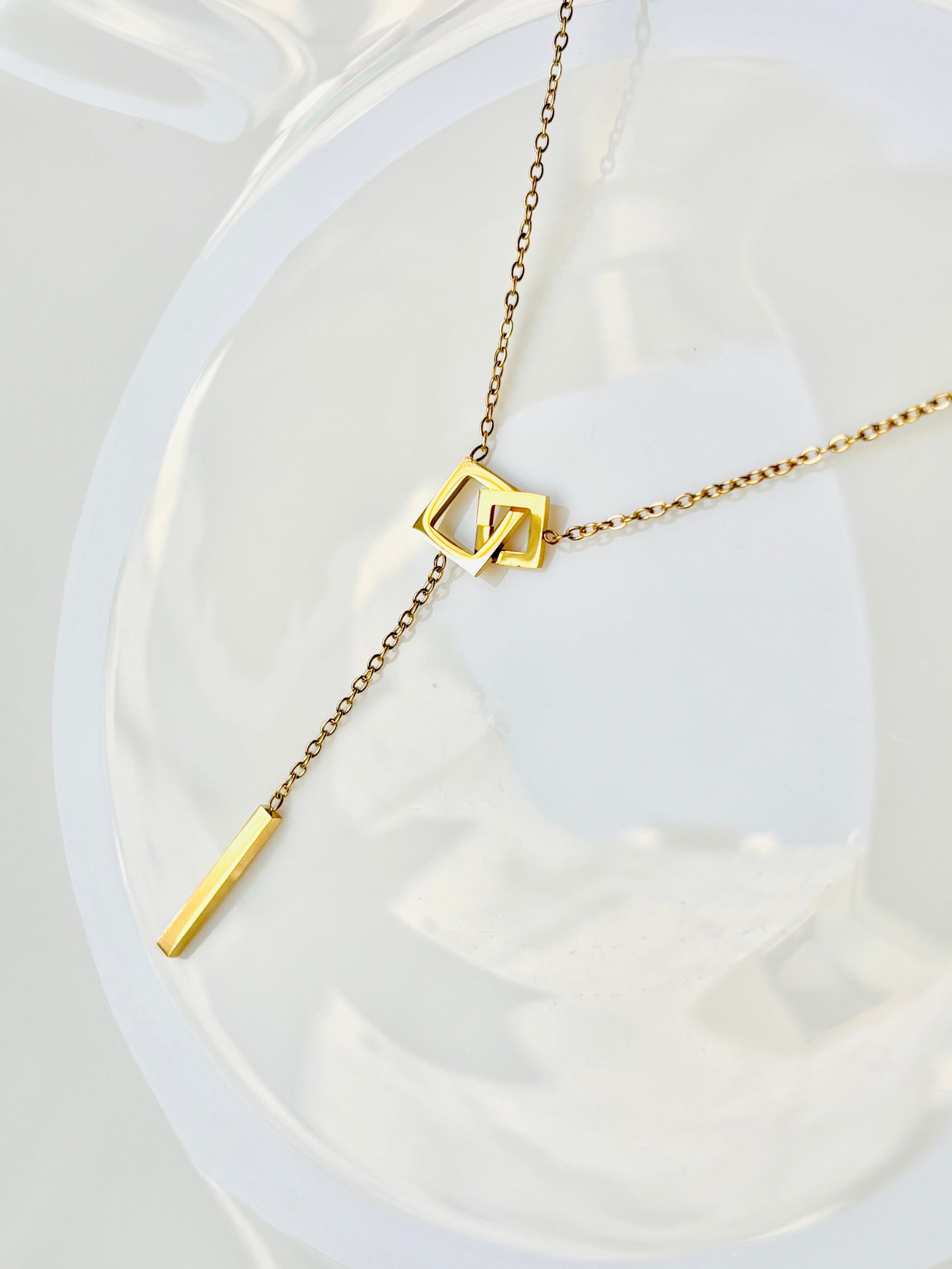 Gold necklace with geometric pendant, square, infinity