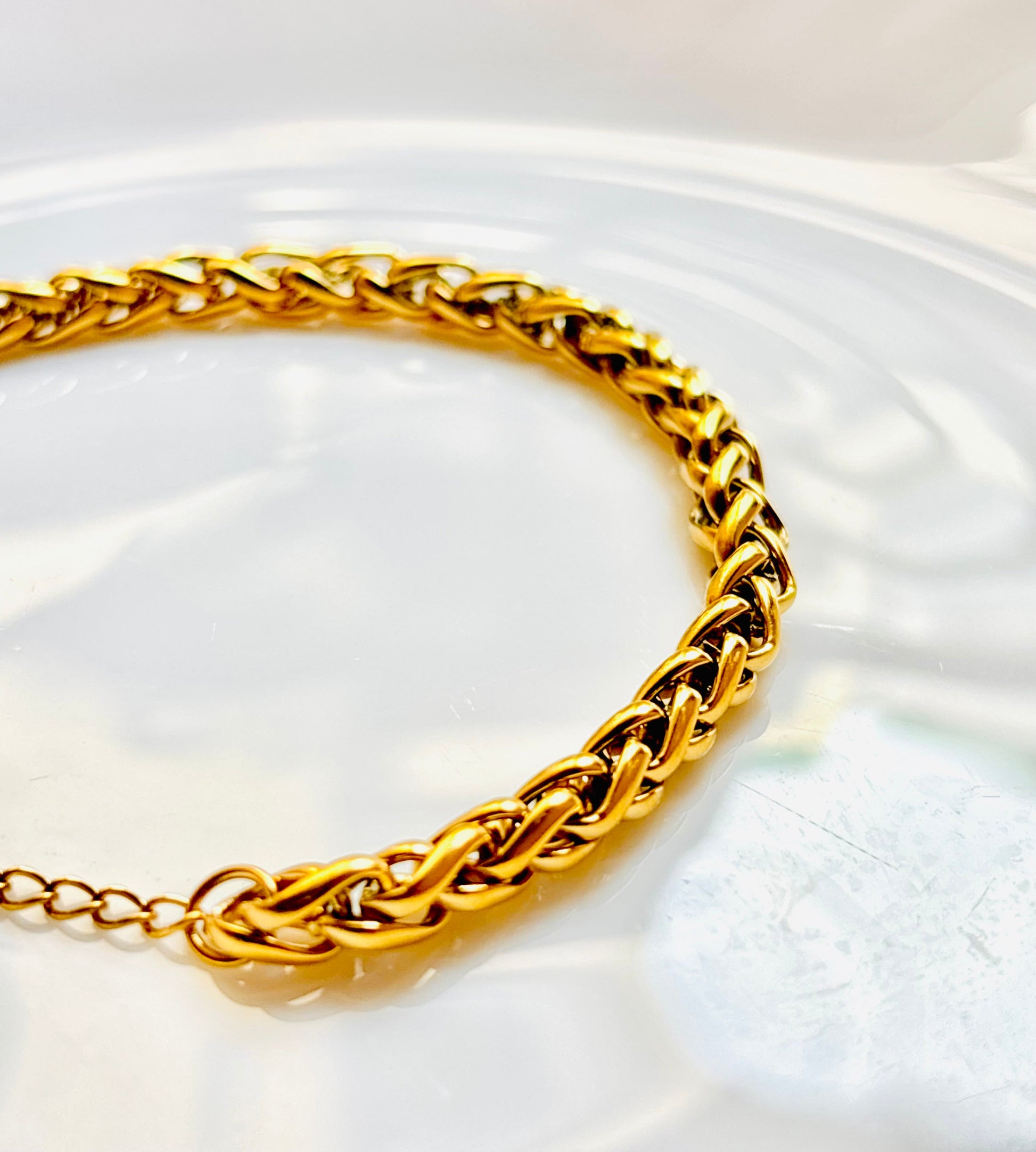 Gold braided bracelet, shiny