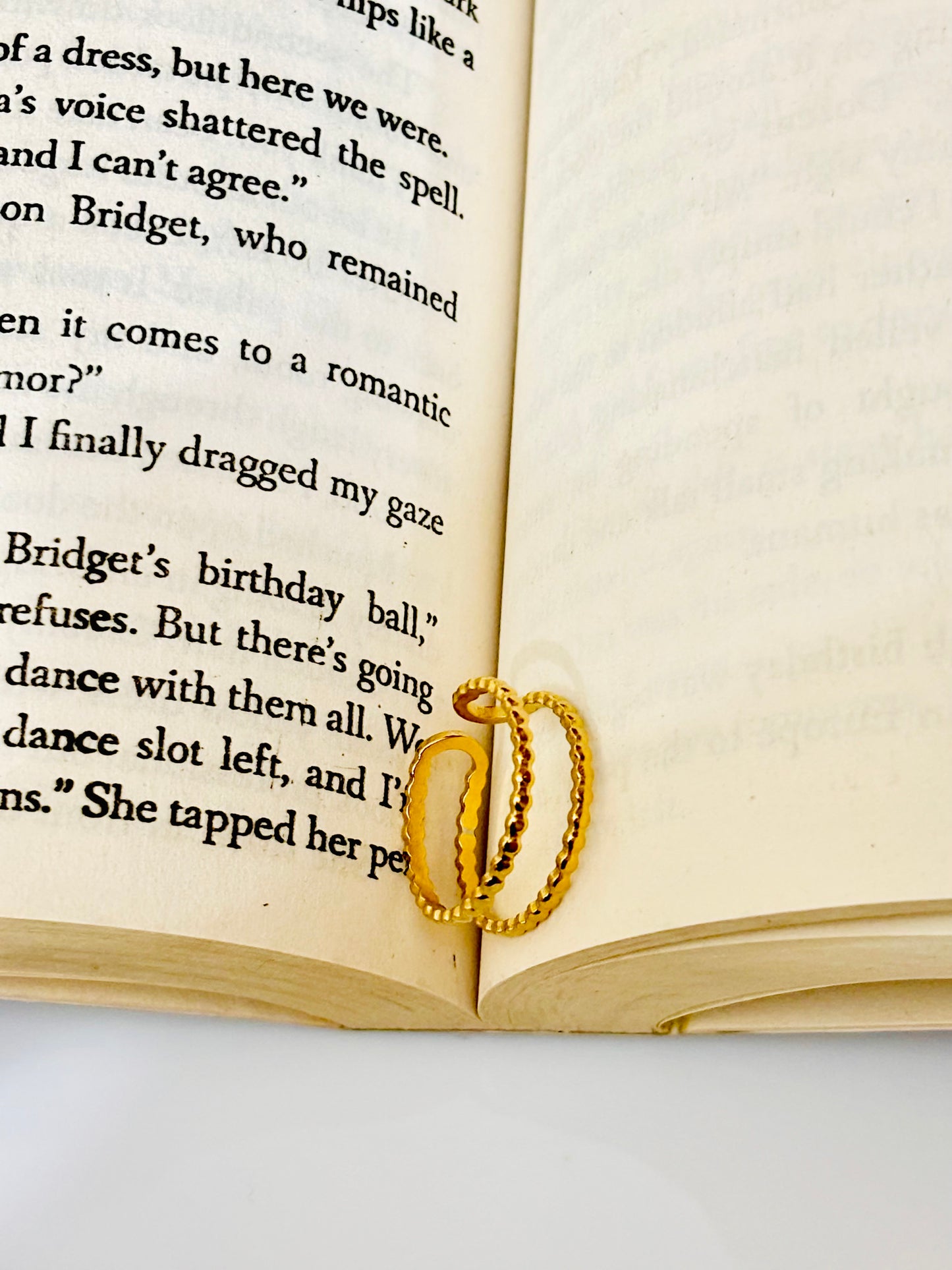 Gold adjustable cute ring on an open book; waterproof & anti tarnish ring