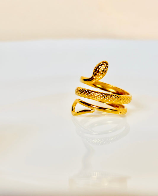 Gold snake-shaped ring on a white surface; waterproof; anti tarnish ring